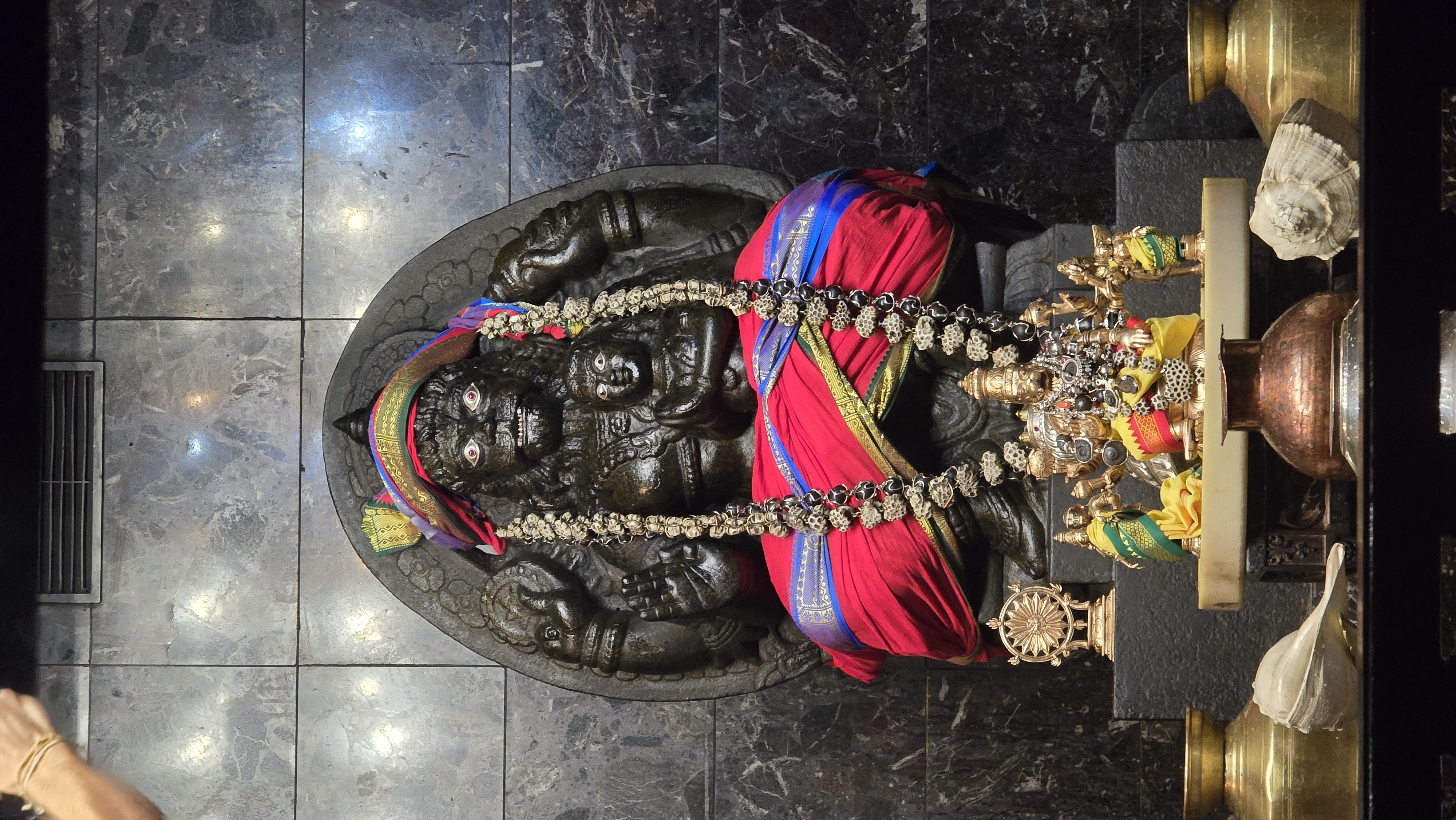 Narasimhadeva altar glowing in lamplight